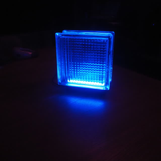 Blue lamp on a table in a dark room